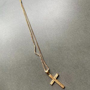 Gold cross chain necklace.